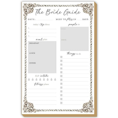 The Bride Guide Simple Silver Pattern Luxe Large Notepad by RosanneBeck Collections is a decorative bridal planning pad on heavy card stock with sections for the date, countdown, top tasks, meal plan, fitness tracking, and more.