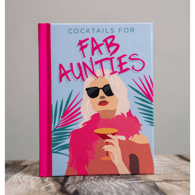 The Cocktails for Fab Aunties Gift Book by Boxer Gifts features an illustrated cover with a blonde woman in sunglasses and a pink feather boa—ideal for anyone looking for fun, fabulous cocktail recipes.