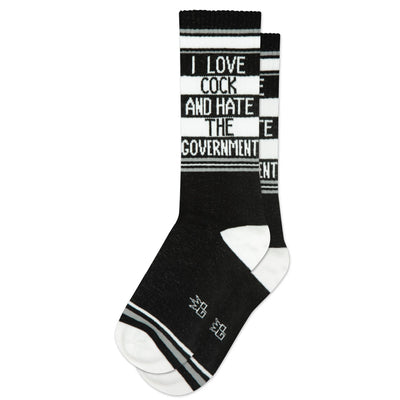 Gumball Poodle’s I Love Cock And Hate The Government Gym Crew Socks feature black and white colors with bold statement text across the calf, perfect for making a rebellious statement. Displayed on a plain white background.