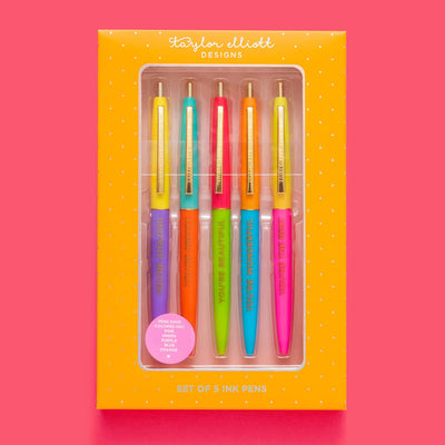 The Taylor Elliott Designs Pen Set - Compliments / Affirmations is a vibrant 5-piece collection of purple, blue, green, orange, and pink ink pens. Packaged in an orange box with gold foil and a clear window, each pen features the uplifting message Youre Beautiful.