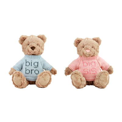 Two Mud Pie Big Sibling Plush Bears sit side by side; one in a blue big bro knit sweater, the other in pink big sis. Both have friendly appearances and weighted seats for stability.