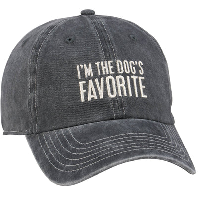 The Dog's Favorite Baseball Cap by Primitives by Kathy is a faded black hat with white "I'M THE DOG'S FAVORITE" stitching, curved brim, and visible stitch details—ideal as a gift for dog lovers.