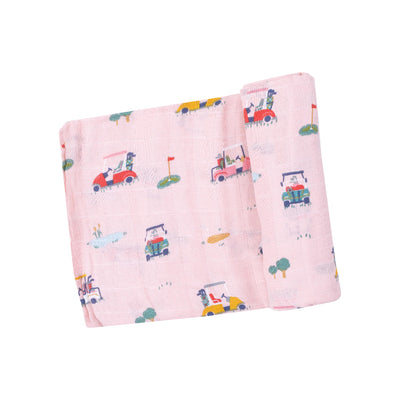 The Pink Golf Cart Cuties Muslin Swaddle Blanket by Angel Dear features a hand-drawn illustration of cars, golf carts, trees, and flags on soft organic cotton muslin. Its neat fold makes it perfect for cozy swaddles.