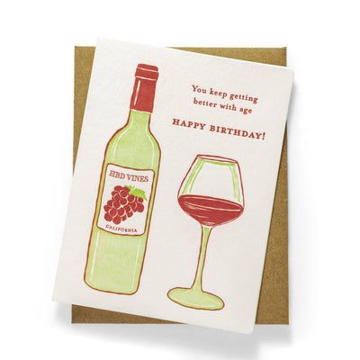 The Wine Birthday Letterpress Greeting Card by Color Box Design & Letterpress features a Red Vines California wine bottle and glass, with You keep getting better with age. Happy Birthday! and comes with a brown envelope.