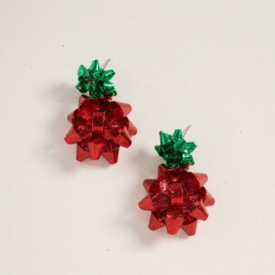 The Two Tone Christmas Bow Post Earrings by Designature New York feature sparkling green and red glitter bows, perfect festive stud earrings to brighten up your holiday season. Shown on a white background.