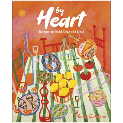 The cover of By Heart: Recipes to Hold Near and Dear by Penguin Random House LLC features a colorful table with lemons, fruit, wine bottles, glasses, and abstract chairs on an orange background—celebrating Italian American cuisine.