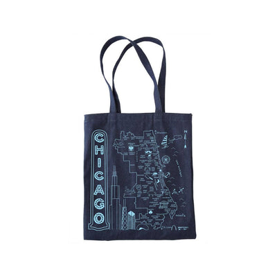 The Chicago Denim Tote by Maptote is a durable bag with a light blue illustrated map of Chicago, labeled landmarks and neighborhoods, and "CHICAGO" printed vertically. Made in Brooklyn.