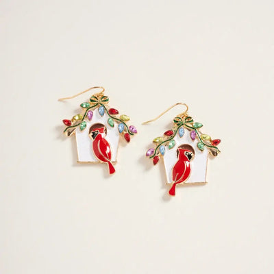 The Golden Stella Christmas Cardinal House Enamel Earrings are 1.75-inch zinc earrings shaped like birdhouses with red cardinals and colorful leaf-shaped gemstones, made in China.