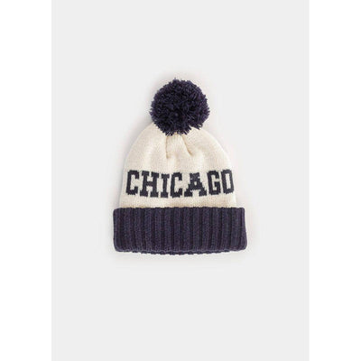 The Alice & Wonder Toddler Mad Hatter Two-Tone Chicago Pom Beanie features a white knit, navy ribbed cuff, large navy pom-pom, and bold "CHICAGO" embroidery across the front.