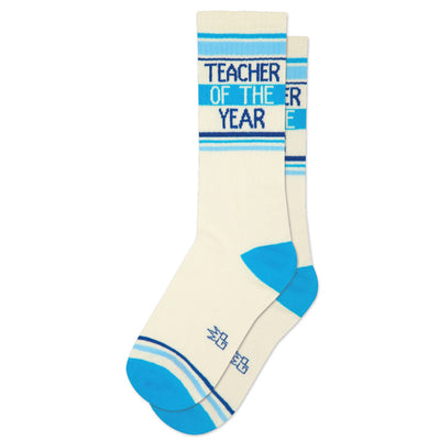 Gumball Poodle’s Teacher Of The Year Gym Crew Socks are cream-colored with blue stripes and accents, featuring “TEACHER OF THE YEAR” in blue and yellow—perfect teacher appreciation or gift for teachers.