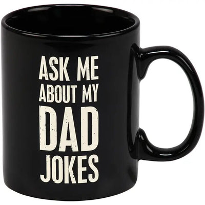 The Dad Jokes Mug by Primitives by Kathy is a 20 oz black stoneware coffee mug with Ask Me About My Dad Jokes in bold white letters. Its microwave safe, ideal for your morning brew or an afternoon laugh.