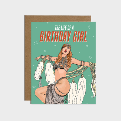 The Life of A Birthday Girl Card by Brittany Paige features an illustrated woman in a glamorous, bejeweled costume on mint green with white stars. Blank inside—perfect as a unique birthday gift or card. Text: The Life of a Birthday Girl.