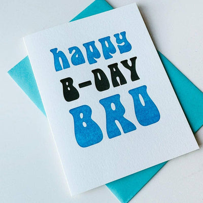 The Steel Petal Press Bro Birthday Letterpress Greeting Card features bold blue and black “happy B-DAY BRO” text on recycled cotton paper, paired with a bright blue envelope and perfect for celebrating your brother’s birthday.