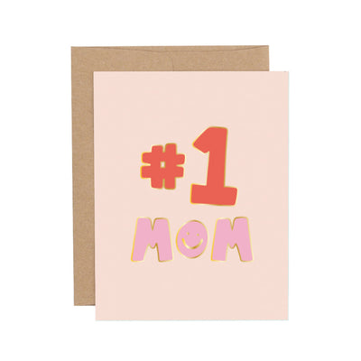 This Callie Danielle greeting card, named Number One Mom Mothers Day Greeting Card, features a beige cover with #1 MOM in bold, colorful letters highlighted by elegant gold foil accents and comes with a plain brown envelope.