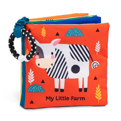 The My Little Farm Children's Cloth Book by Wendy Kendall, from Hachette Book Group, is a colorful soft fabric book for babies featuring a cartoon cow cover and a black-and-white teether ring on the upper left corner.