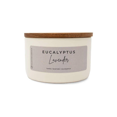 The Eucalyptus Lavender Statement Candle by Milkhouse Candle Company features a minimalist label and wooden lid. Made from natural soy wax, it’s highly scented for a soothing atmosphere with notes of lavender and eucalyptus.