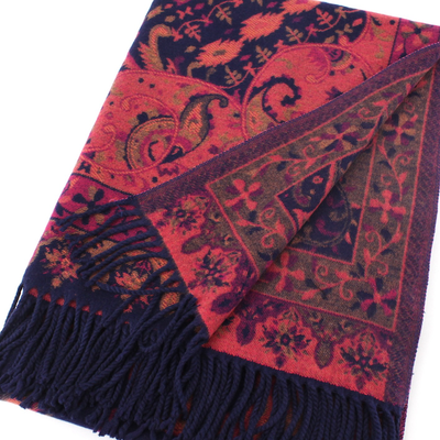 The Melange Scarf by Pretty Persuasions features a soft wool blend with red, navy, and gold paisley floral patterns, intricate designs, fringed edges, and a folded corner to display both sides.