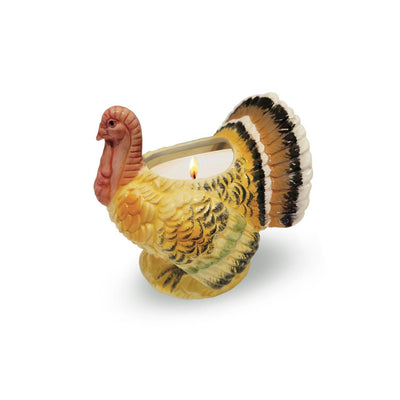 The Aunt Sadie's Candles Ceramic Thanksgiving Turkey Candle features a turkey-shaped ceramic holder in yellow, orange, and brown with a lit Pumpkin Pie-scented candle, set against a plain white background.