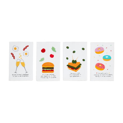 The Boucle Food Towels by Mud Pie are a charming set of four white embroidered cotton towels with delightful designs, including champagne glasses with eggs, a burger, a sandwich with olives, and colorful donuts, each paired with humorous text to brighten any kitchen.