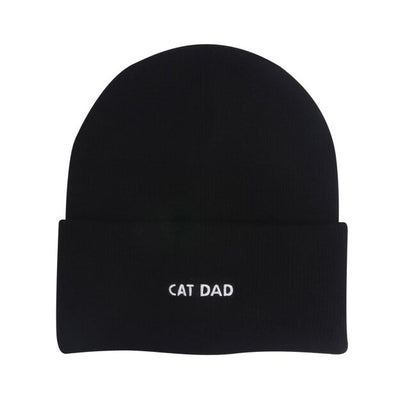 The HATPHILE Cat Dad Embroidered Beanie Hat features "CAT DAD" in white on the front fold, made from stretch knit fabric for comfort and warmth, shown against a plain white background.