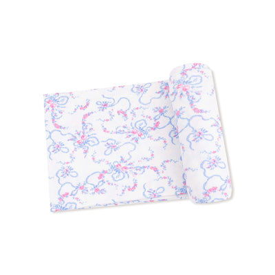 The Angel Dear Ribbon Floral Fling Ribbed Swaddle Blanket features a white, textured design with a rolled edge, adorned with delicate blue and pink floral patterns.
