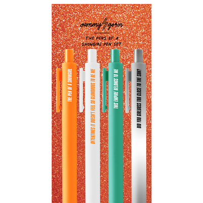 Four vibrant black gel ink pens (orange, yellow, white, teal) from The Pens of a SG Pen Set by Sammy Gorin LLC stand upright on a sparkly orange background. Each 0.5mm pen displays a unique phrase from the set.