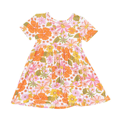 The Boho Beachy Floral Short Sleeve Twirly Dress by Angel Dear features soft Viscose from Bamboo, a round neckline, gathered flared skirt, and a colorful floral print with orange, pink, yellow flowers and green leaves.