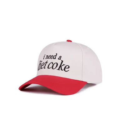 The I Need A Diet Coke Two Tone Baseball Cap by 42POPS features a black crown, red brim, bold front print, and an adjustable strap for comfort. This lightweight cotton cap is both breathable and stylish.