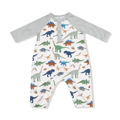 The Washy Dinos Raglan Henley Romper by Angel Dear features light gray sleeves, a white body, colorful dinosaur print, and is made from soft bamboo viscose with snap buttons on the chest and legs for easy changes.