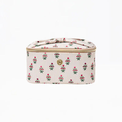 The Kiss and Make Up Cosmetic Travel Bag in Cottage Stripes by Mary Square features beige and white stripes, delicate pink and green florals, a gold emblem, and a zippered closure—ideal for stylish cosmetic storage on the go.
