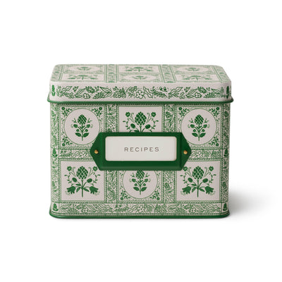 The Artichoke Recipe Tin by Rifle Paper Co. is a green and white metal box with floral and geometric designs, perfect for organizing recipe cards or storing family recipes. The front features a label that says "RECIPES.