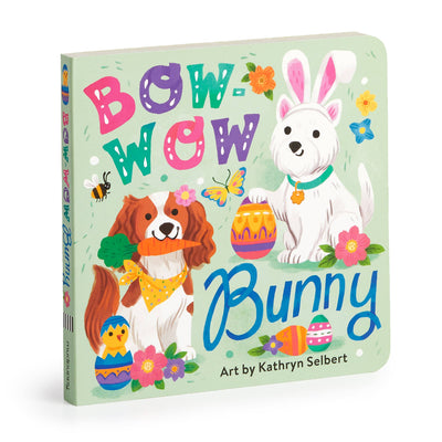 The cover of the Bow-wow Bunny Board Book from Chronicle Books features vibrant illustrations of a dog with bunny ears, another holding an egg, and Easter decorations, surrounded by flowers and a bee. Art by Kathryn Selbert ensures kids enjoy the springtime theme.