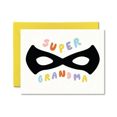The Super Grandma Card by pretty by her features Super Grandma in colorful letters above a black superhero mask on matte cardstock. It includes a yellow envelope and is the ideal A2 folded card to celebrate the special hero in your life.