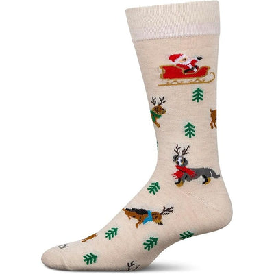 The MeMoi Reindeer Pups Bamboo Men's Crew Socks feature a festive beige design with Santa in a red sleigh, reindeer, green trees, and snowflakes. Made from soft bamboo and shown on a plain white background.