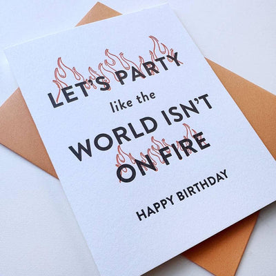 The World on Fire Birthday letterpress card by Steel Petal Press features flames over LETS PARTY like the WORLD ISNT ON FIRE. HAPPY BIRTHDAY, printed on recycled cotton rag paper and displayed with a brown envelope.