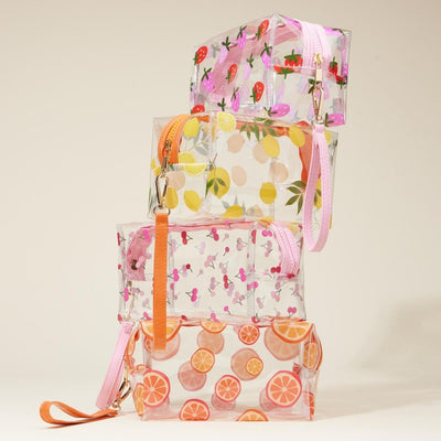 The Judson & Company Clear Fruit Pattern Cosmetic Cases are a set of four stacked travel pouches, each with a unique print—strawberries, lemons, flamingos, and orange slices—plus full zipper closures and removable pink or orange wristlet straps.