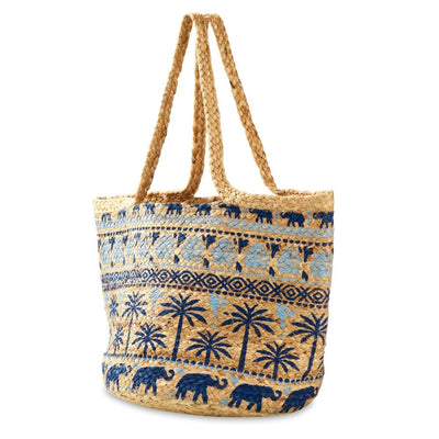 The Judson & Company Woven Jute Tote Bag features painted elephant and palm tree designs, braided handles, a strap drop, and measures approx. 18 L x 12 T x 13 D. Made in India.