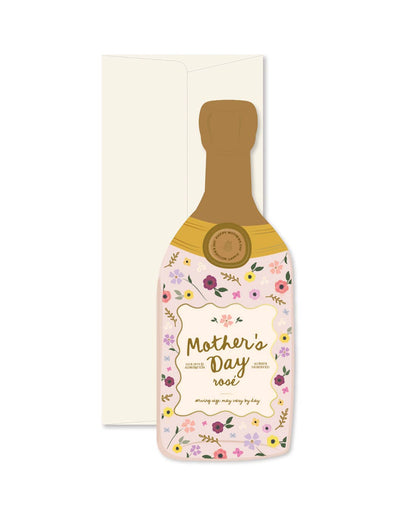 The Mothers Day Rosé Bottle Greeting Card by Ginger P. Designs is a die-cut, bottle-shaped card featuring colorful flowers and Mothers Day Rosé in elegant script, complete with a cream-colored envelope—perfect for celebrating Mom.