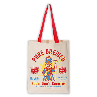 The Chicago Style Pope Tote by Transit Tees is a beige cotton canvas bag with red handles, featuring a colorful bishop and “Pure Brewed From God’s Country” text with beer-themed phrases in red, yellow, and blue.