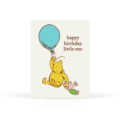The Sweet Bippy Press Happy Birthday Little One Greeting Card features a cartoon bear with a blue balloon and a piglet on the ground, “happy birthday little one” text, and is printed on FSC certified paper with a white background.