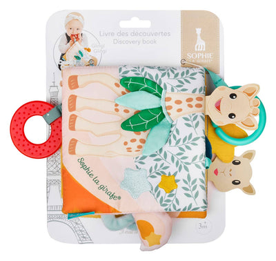 The Sophie la Giraffe Discovery Book by Calisson Toys is a soft baby book with colorful pages and an attached red teether to engage babys curiosity. Featuring a giraffe face toy, its perfect for stimulating senses from 3 months. Packaging adorned with the Eiffel Tower includes text in French and English.