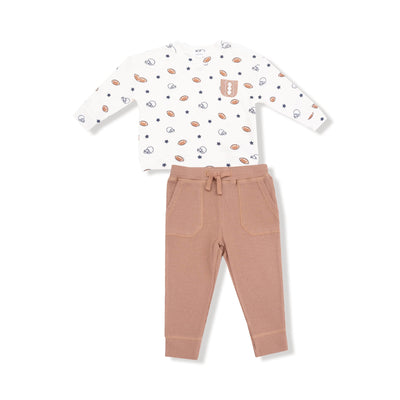 The Angel Dear Footballs and Stars Drop Sleeve Shirt with Pocket and Jogger is a sporty kids outfit featuring a long-sleeve shirt with football and star prints, paired with joggers that have an elastic waistband and pockets.