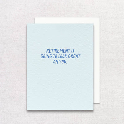 The Retirement is Going to Look Great on You Greeting Card by Gert & Co features blue capital letters on a light blue card and is made by a woman-owned brand.