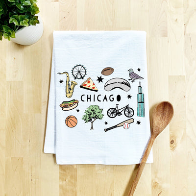 The Moonlight Makers Colorful Chicago Collage Dish Towel features illustrated icons like a saxophone, Ferris wheel, pizza slice, and hot dog. This unique, non-toxic kitchen towel is perfect for adding Windy City flair to your home.