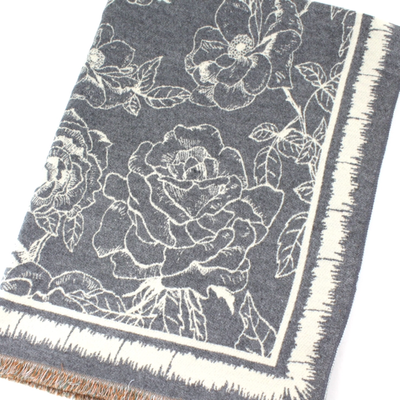The Pretty Persuasions Polyester Reversible Patterned Scarf features a grey and white floral rose design with large, detailed leaves and a fringed edge. Made from 100% polyester for softness and durability.