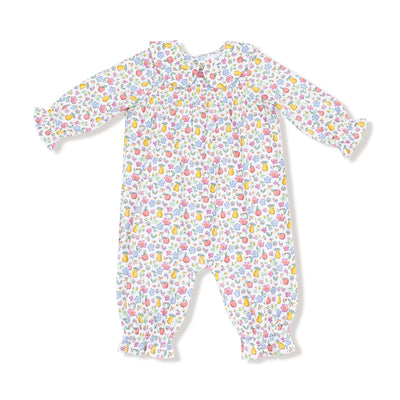 The Fall Fruit Floral Smocked Romper by Angel Dear is a long-sleeved, machine-washable bamboo viscose baby romper with a colorful fruit and floral print, ruffled cuffs, and gathered chest detail.