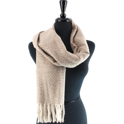 The Pretty Persuasions Locklyn Scarf, featuring a beige and cream pattern with fringe, is shown draped around the neck of a black mannequin torso against a plain white background.