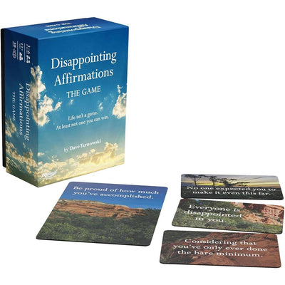 A box labeled Disappointing Affirmations: The Disappointing Game by Chronicle Books is displayed beside four cards with darkly humorous, discouraging phrases—like Everyone is disappointed in you—on scenic backgrounds.