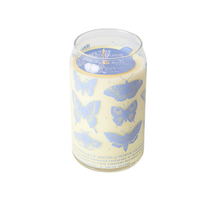 The Butterflies & Moths Soy Candle from Good & Well Supply Co.s Forest Floor Collection is a hand-poured candle in a soda can-style transparent glass jar. It features field guide-inspired illustrations of butterflies and moths on a cream background, with a pull-tab lid for an authentic touch.