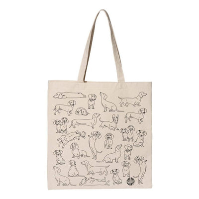 The Sween Shop Dachshund Tote Bag is a beige cotton canvas tote with black line dachshunds in playful poses, arranged in rows—ideal as a reusable shopping bag for dog lovers.